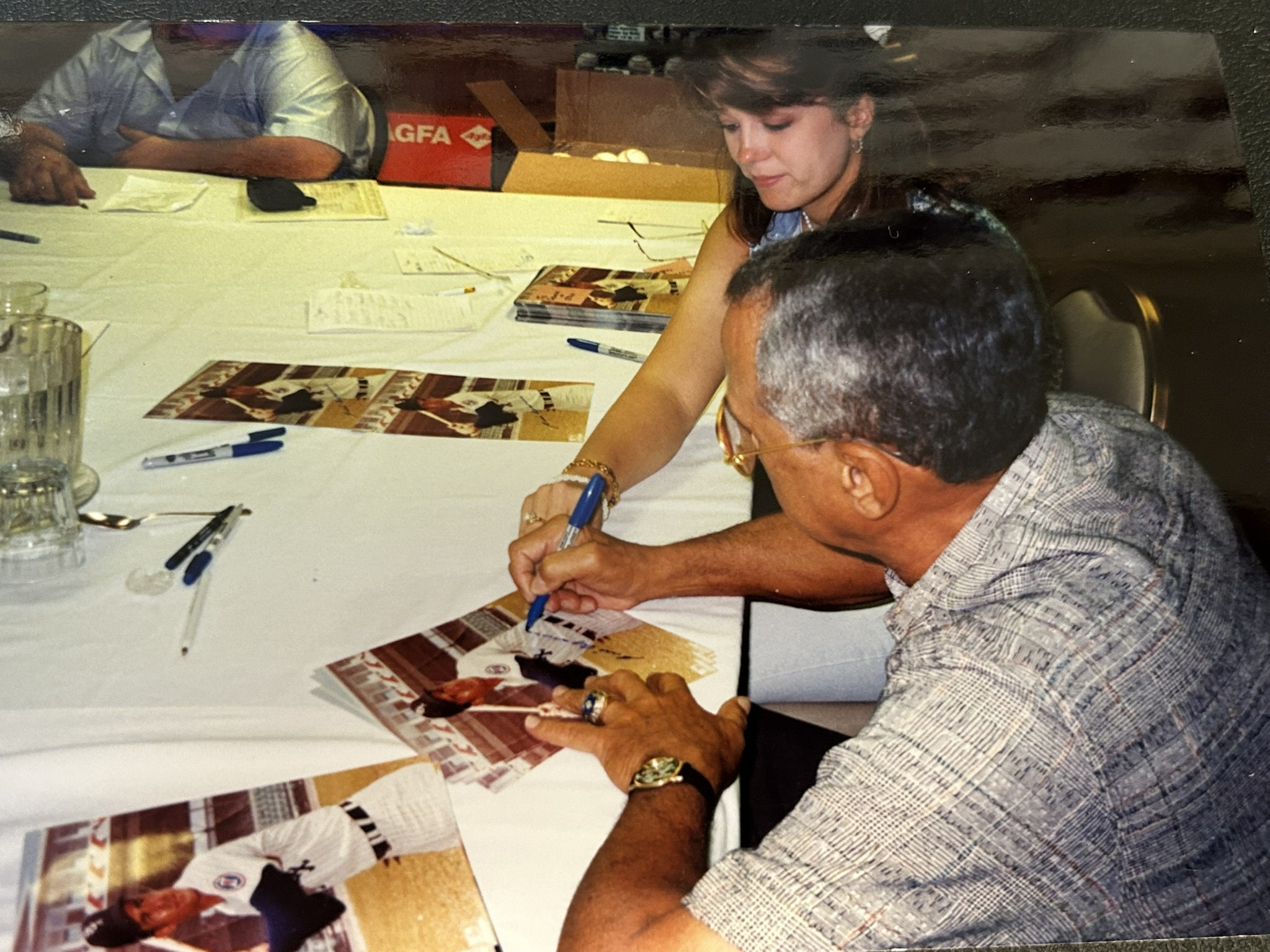 Luis Aparicio signing photographs for Stan Fitzgerald on May 16, 1998.
